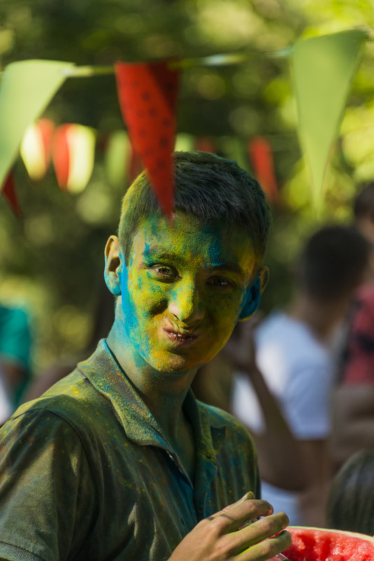 Funny young man with a painted face eating watermelon - Сергей 